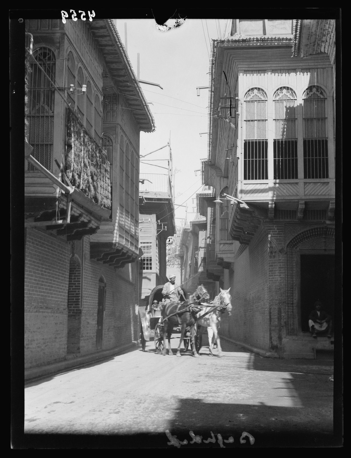 Rabbi Isaac Gaon Shrine — Visual context: a Baghdad street with traditional overhanging balconies, photographed in 1932. This is not a photograph of the exact heritage site.